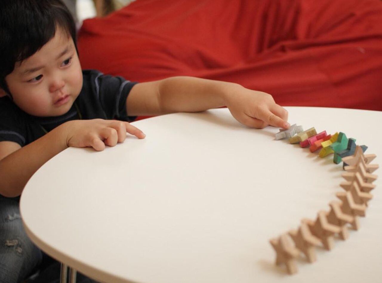 a little boy playing domino