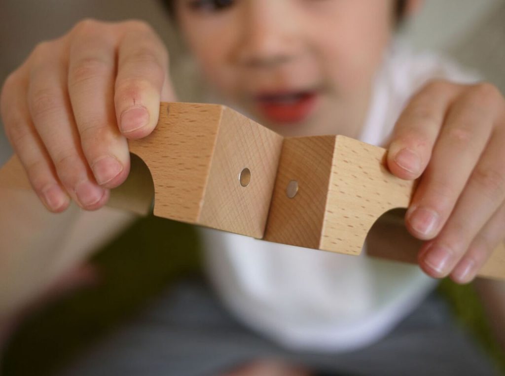 a child holding a piece of wood
